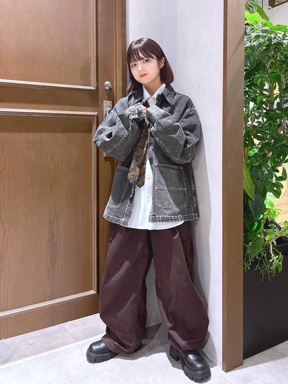 ブラウン系のカーゴパンツ、ホワイト系のシャツ/ブラウス、その他のネクタイを着用したレディースの秋コーディネートの2枚目の写真