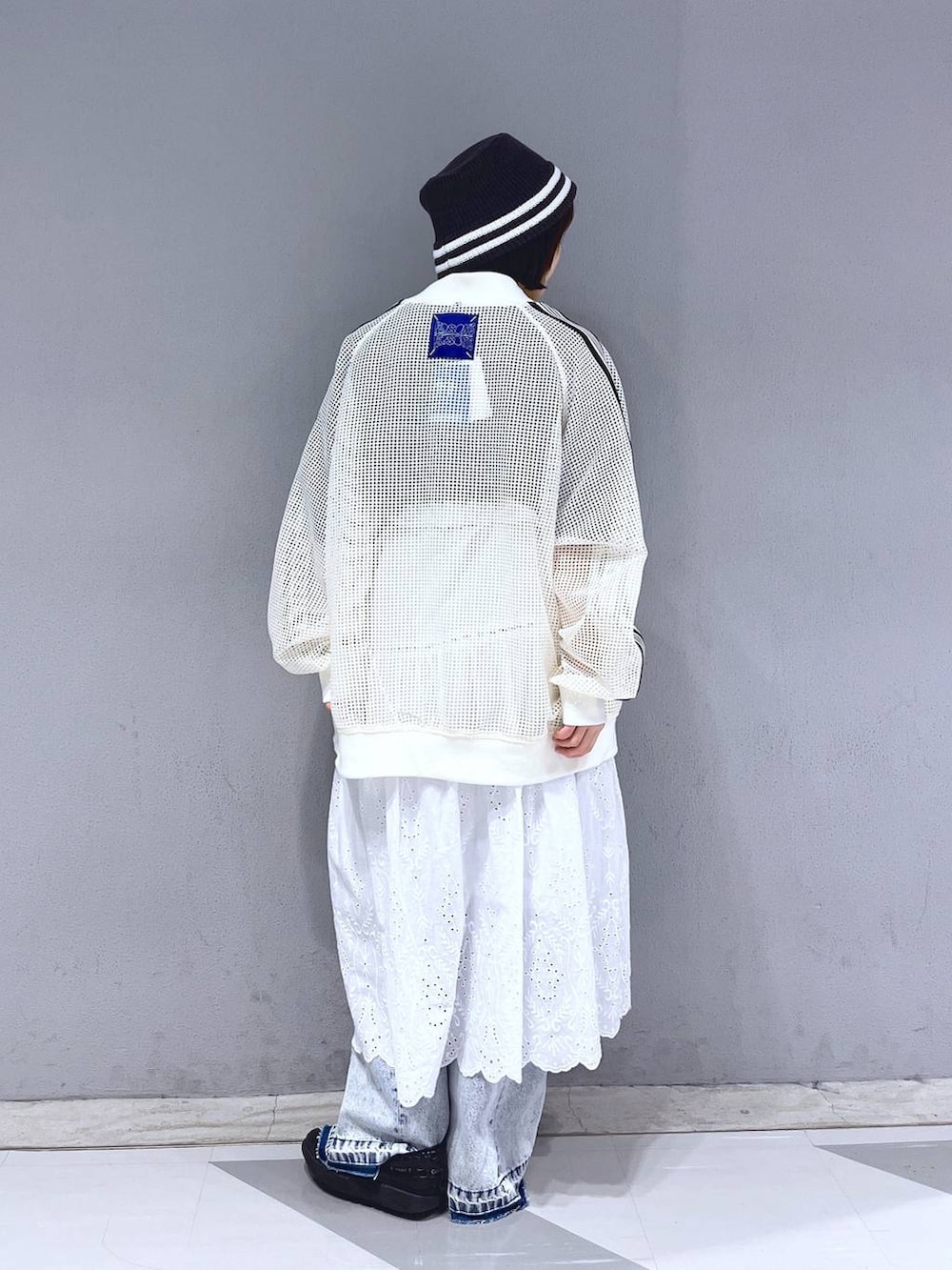 ホワイト系のブルゾン、ブラック系のTシャツ/カットソー、ホワイト系のスカートを着用したレディースの春コーディネートの3枚目の写真