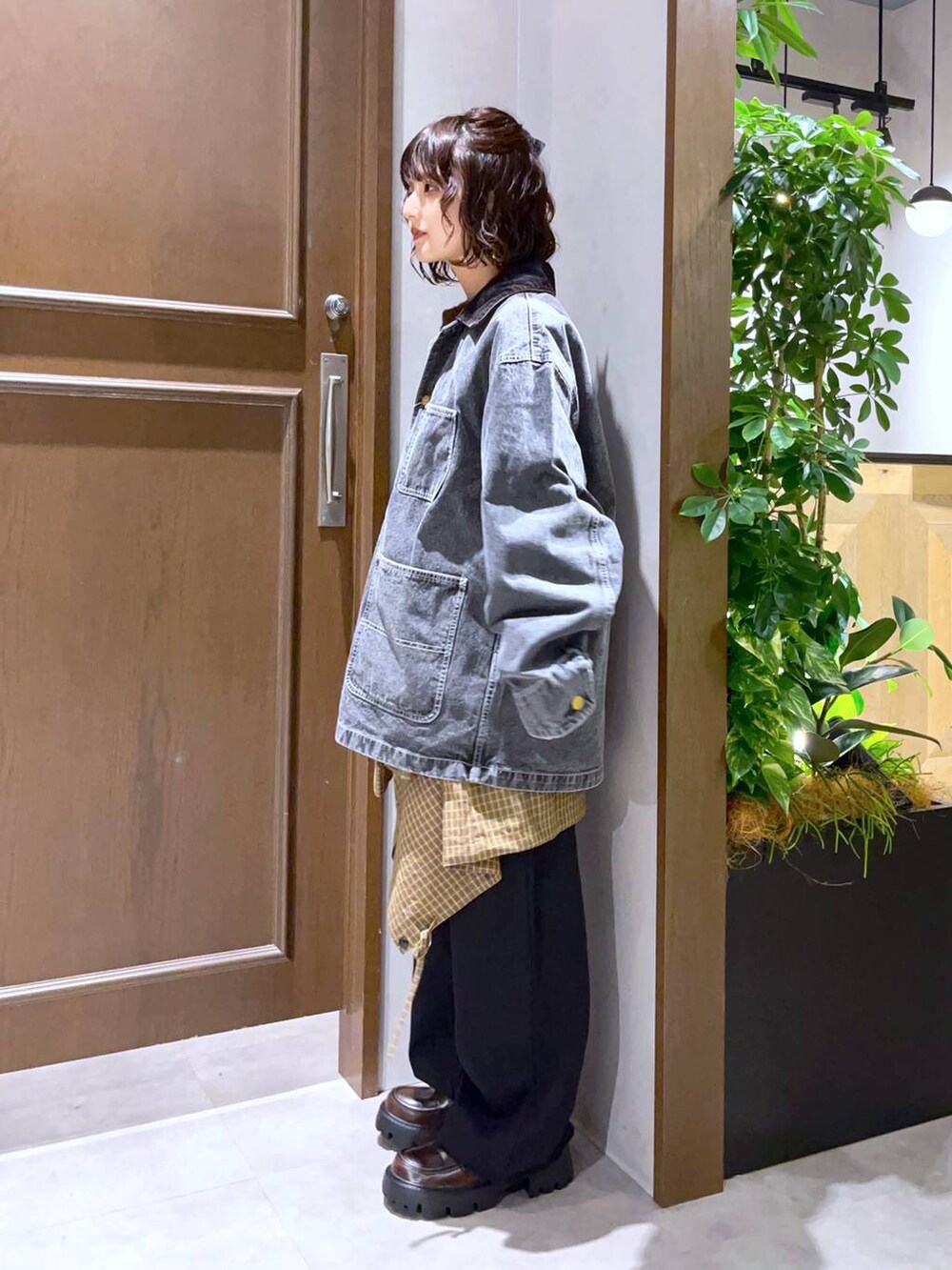 グレー系のブルゾン、イエロー系のシャツ/ブラウス、ブラウン系のニット/セーターを着用したレディースの秋コーディネートの3枚目の写真