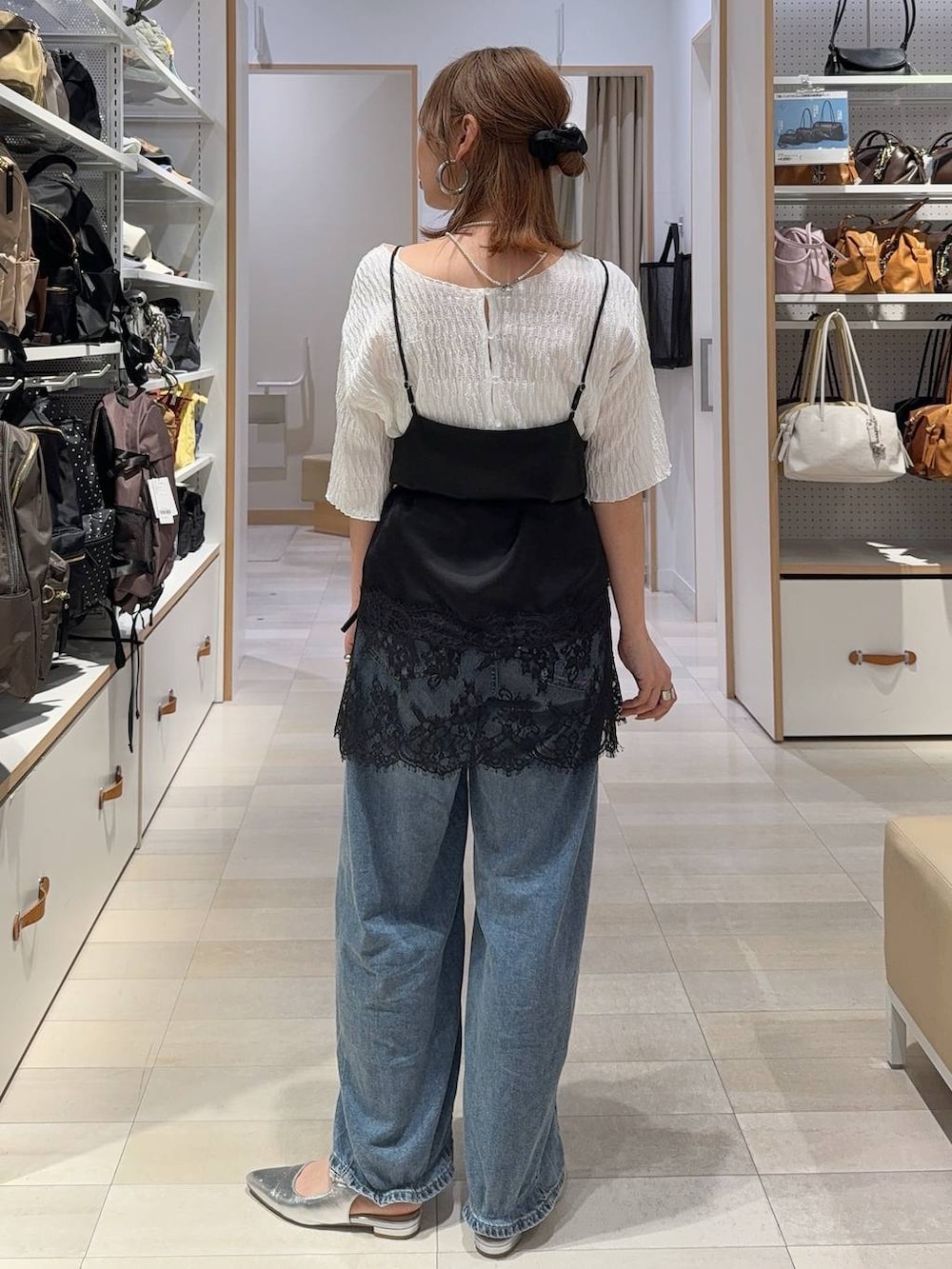 ブルー系のデニムパンツ、ブラック系のキャミソール、ブルー系のカーディガン/ボレロを着用したレディースの春コーディネートの8枚目の写真