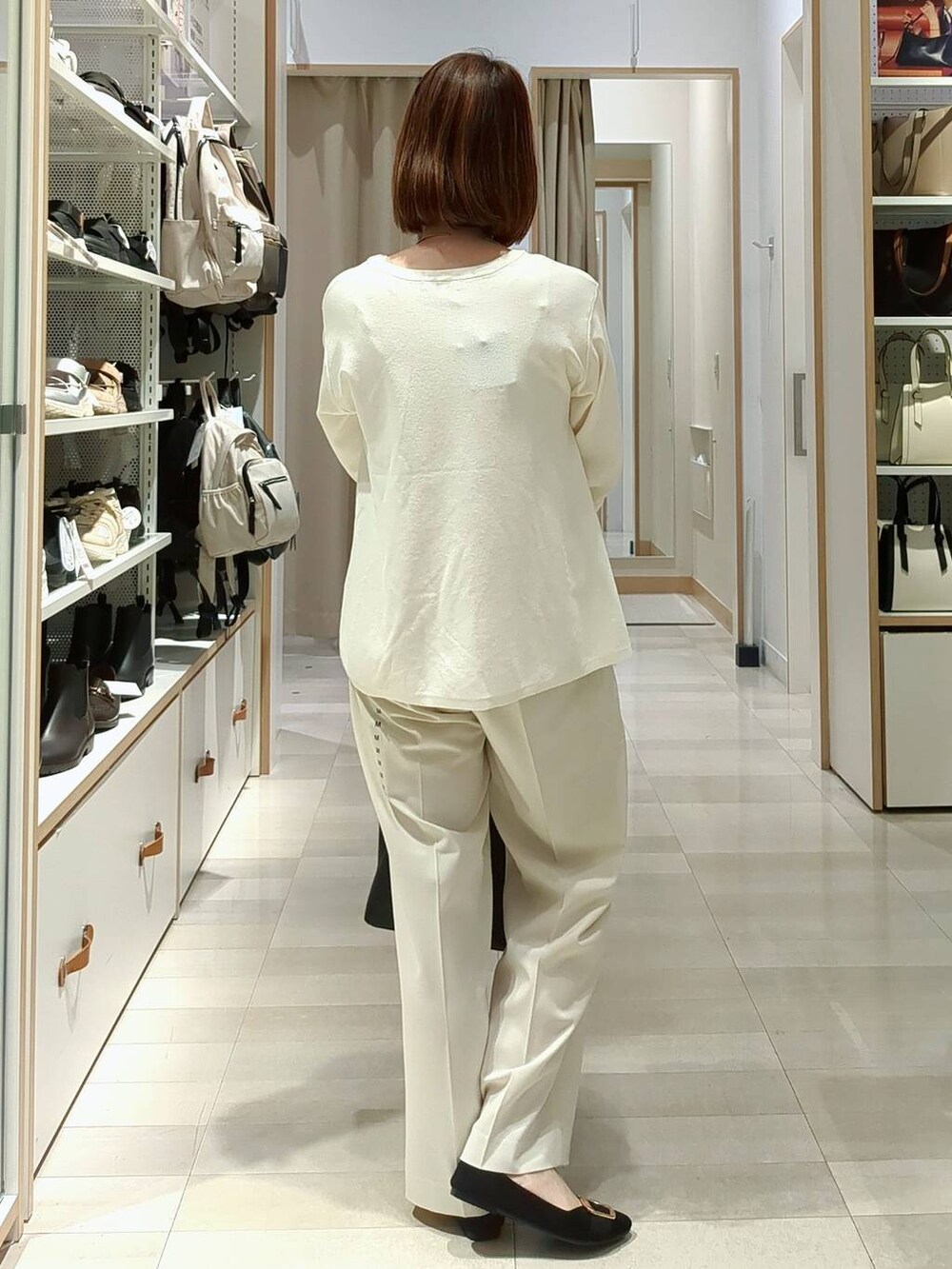 ホワイト系のその他パンツ、ホワイト系のニット/セーター、ベージュ系のベストを着用したレディースの春コーディネートの9枚目の写真