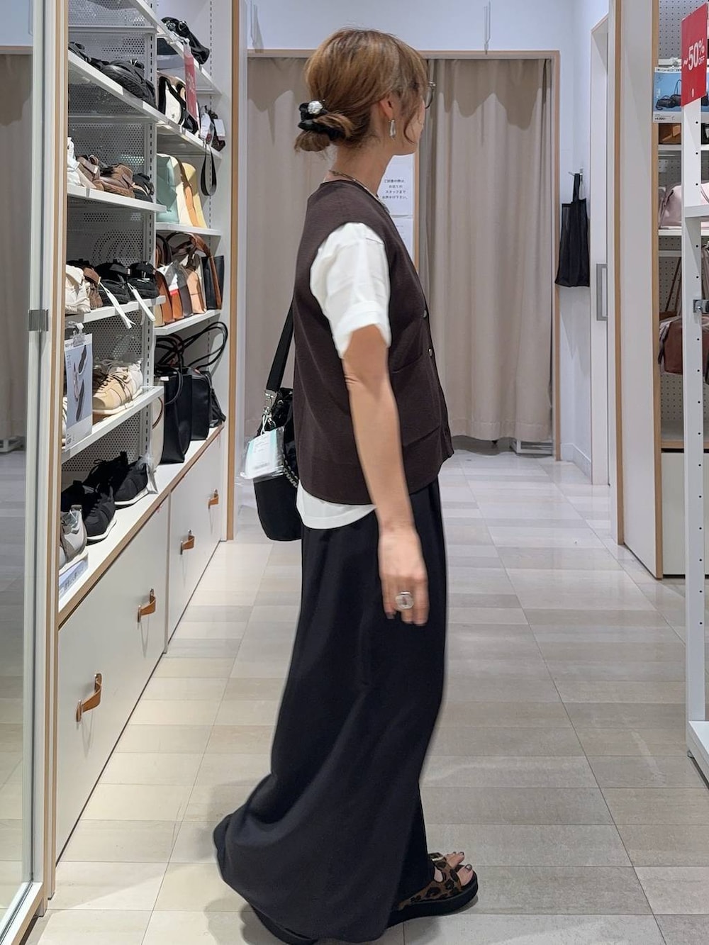 ブラック系のその他パンツ、ホワイト系のTシャツ/カットソー、ブラウン系のベストを着用したレディースの夏コーディネートの3枚目の写真
