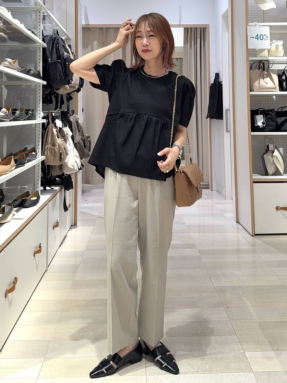 ブルー系のデニムパンツ、グレー系のボストンバッグ、ブラック系のカーディガン/ボレロを着用したレディースの夏コーディネートの4枚目の写真