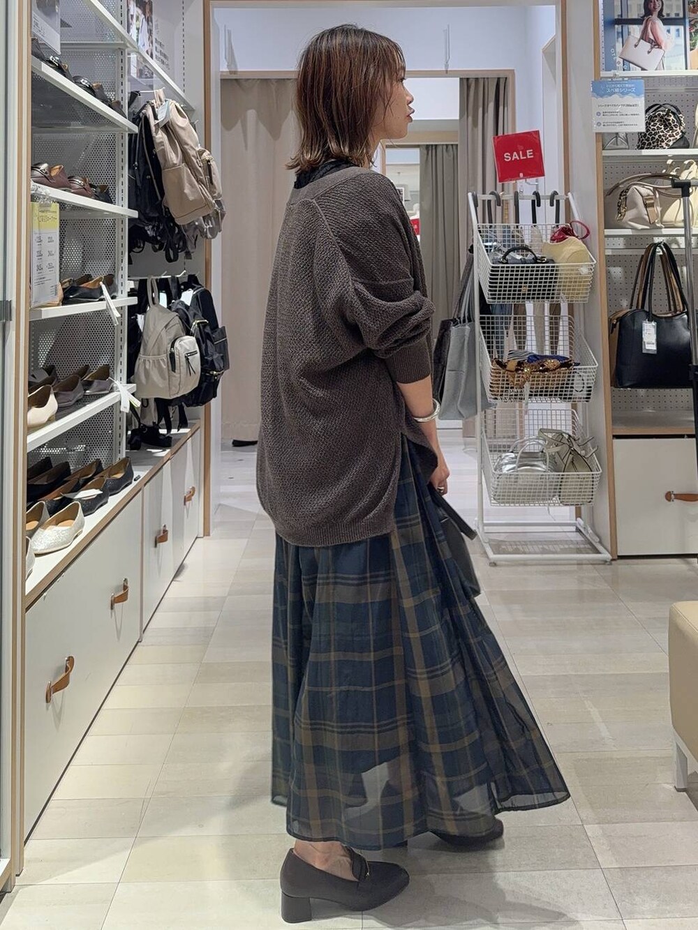 ブラック系のショルダーバッグ、ホワイト系のスニーカー、ブラック系のローファーを着用したレディースの夏コーディネートの4枚目の写真