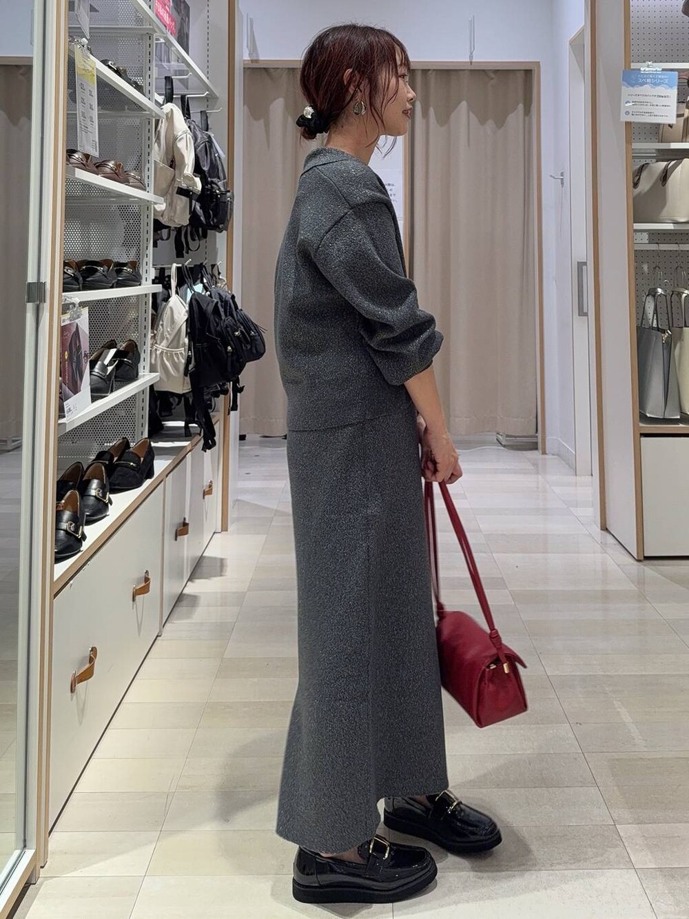 ブラック系のスニーカー、ブルー系のデニムジャケット、シルバー系のハンドバッグを着用したレディースの秋コーディネートの8枚目の写真