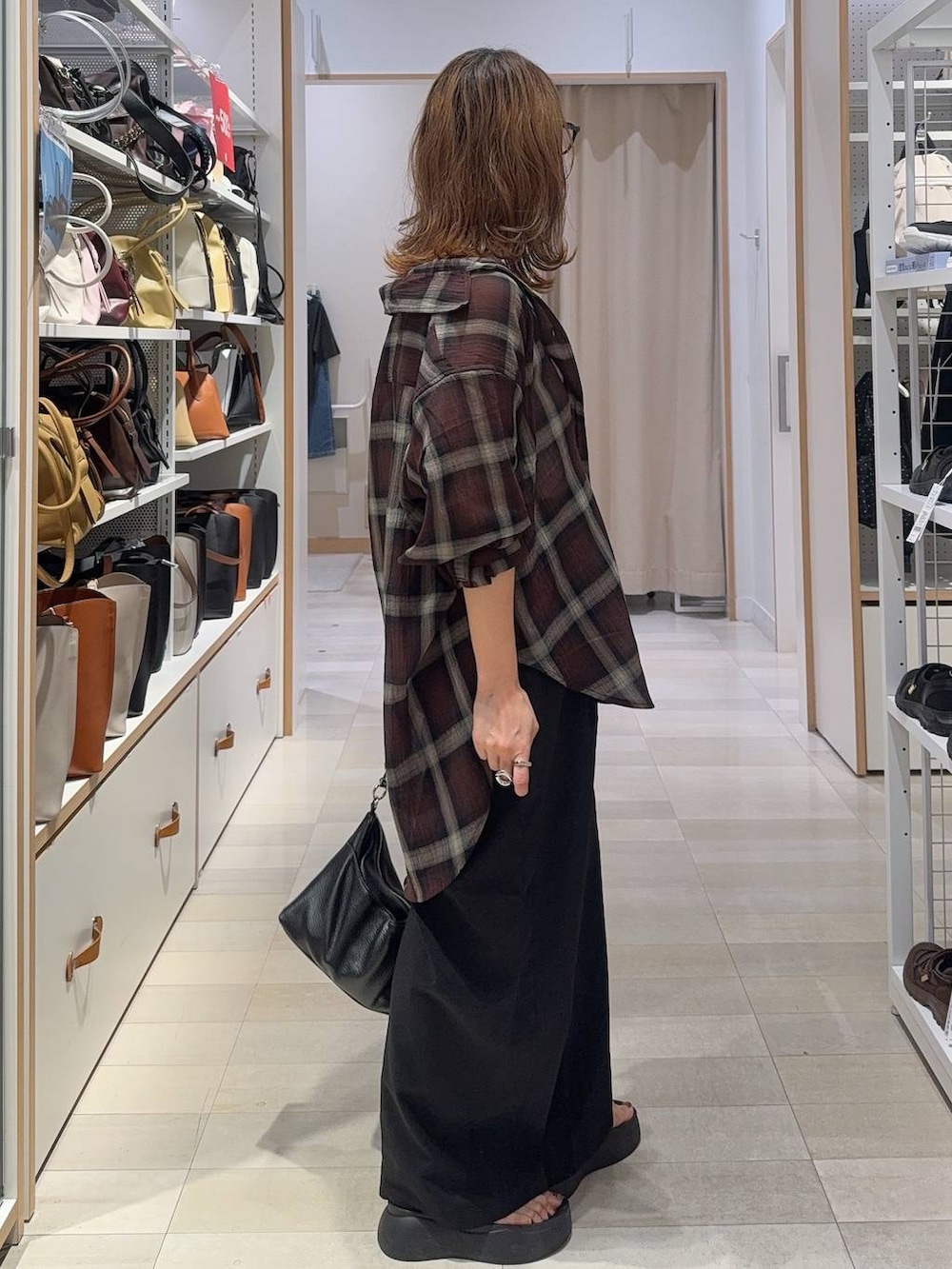 ブラック系のその他パンツ、ブラウン系のシャツ/ブラウス、シルバー系のネックレスを着用したレディースの夏コーディネートの3枚目の写真