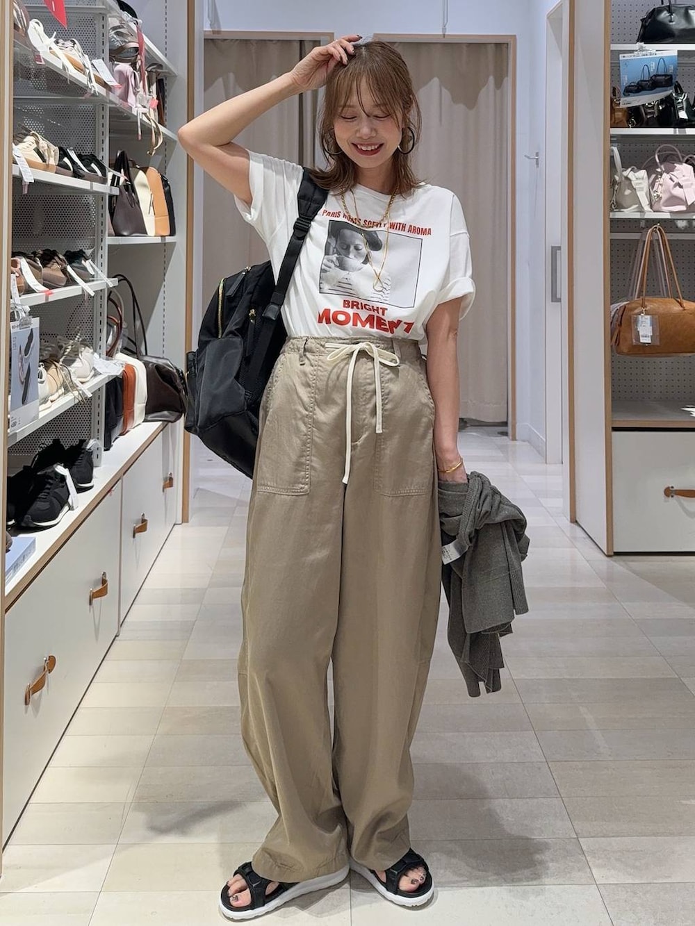 ブラック系のサロペット/オーバーオール、ホワイト系のTシャツ/カットソー、ブラック系のサンダルを着用したレディースの夏コーディネートの3枚目の写真