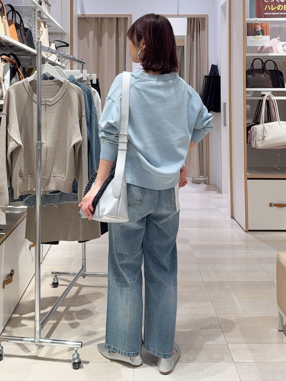 シルバー系のパンプス、ブラック系のキャミソール、ブルー系のデニムパンツを着用したレディースの冬コーディネートの9枚目の写真