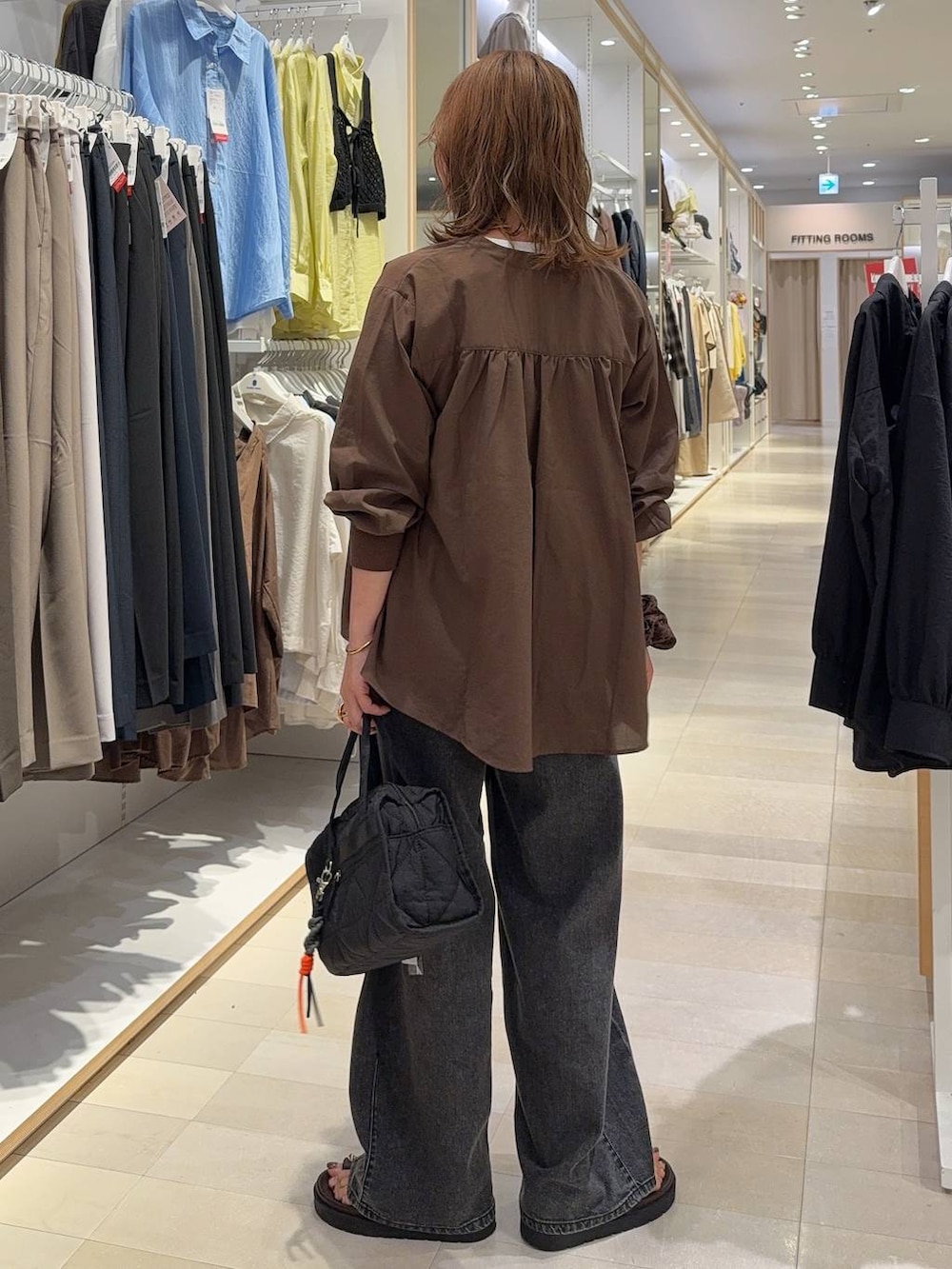 ブラック系のボストンバッグ、ブラック系のデニムパンツ、ホワイト系のTシャツ/カットソーを着用したレディースの夏コーディネートの5枚目の写真