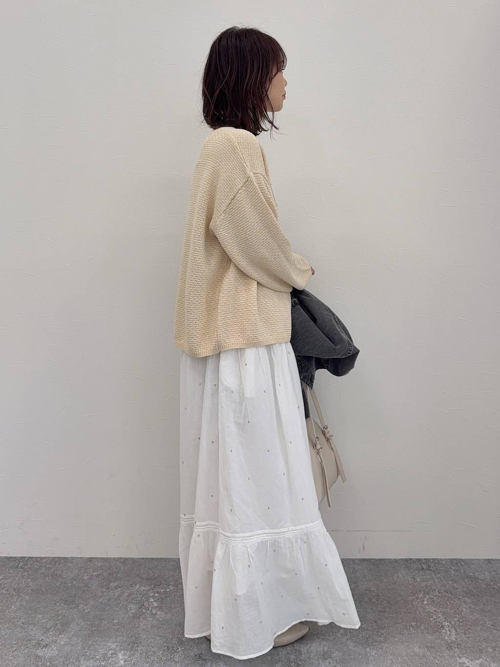 ホワイト系のパンプス、ベージュ系のショルダーバッグ、シルバー系のネックレスを着用したレディースの春コーディネートの6枚目の写真