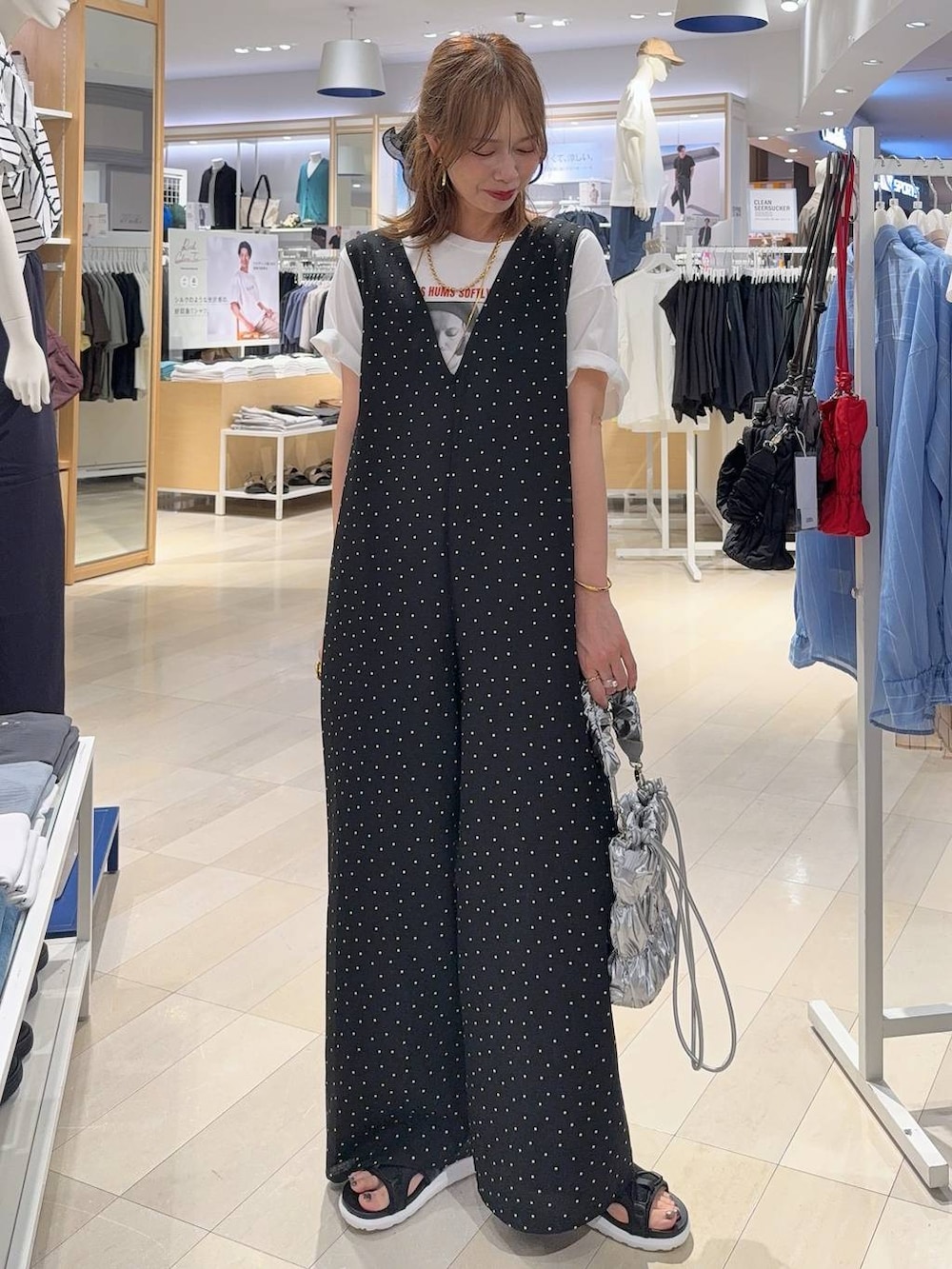 ブラック系のサロペット/オーバーオール、ベージュ系のTシャツ/カットソー、ブラック系のサンダルを着用したレディースの夏コーディネートの2枚目の写真