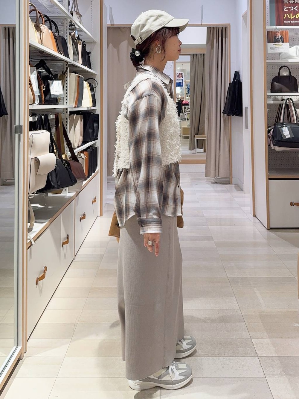 ホワイト系のショルダーバッグ、ホワイト系のスニーカー、ブラウン系のテーラードジャケットを着用したレディースの冬コーディネートの6枚目の写真