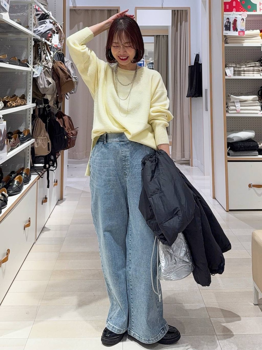 ブラック系のローファー、ブラック系のダウンジャケット/コート、シルバー系のハンドバッグを着用したレディースの冬コーディネートの2枚目の写真