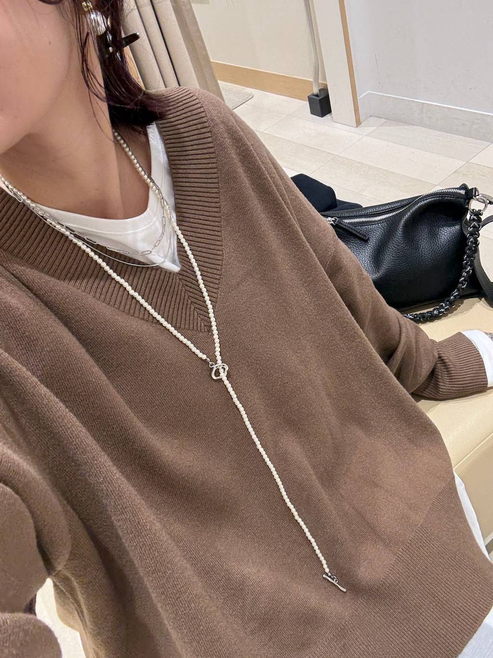 ブルー系のチェスターコート、ホワイト系のTシャツ/カットソー、ブラウン系のその他パンツを着用したレディースの冬コーディネートの3枚目の写真