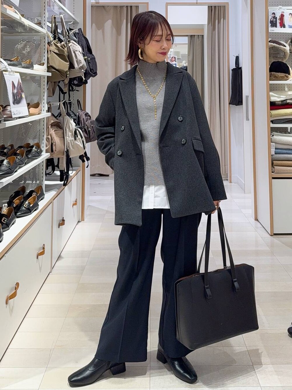 ブラック系のトートバッグ、ブルー系のその他パンツ、ホワイト系のTシャツ/カットソーを着用したレディースの秋コーディネートの2枚目の写真