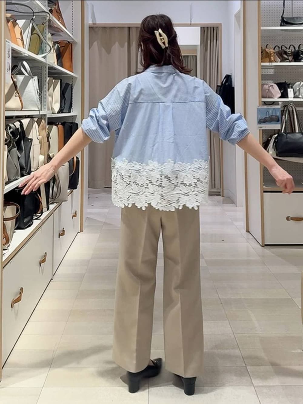 ベージュ系のその他パンツ、ブラック系のカーディガン/ボレロ、ブラック系のボストンバッグを着用したレディースの春コーディネートの6枚目の写真