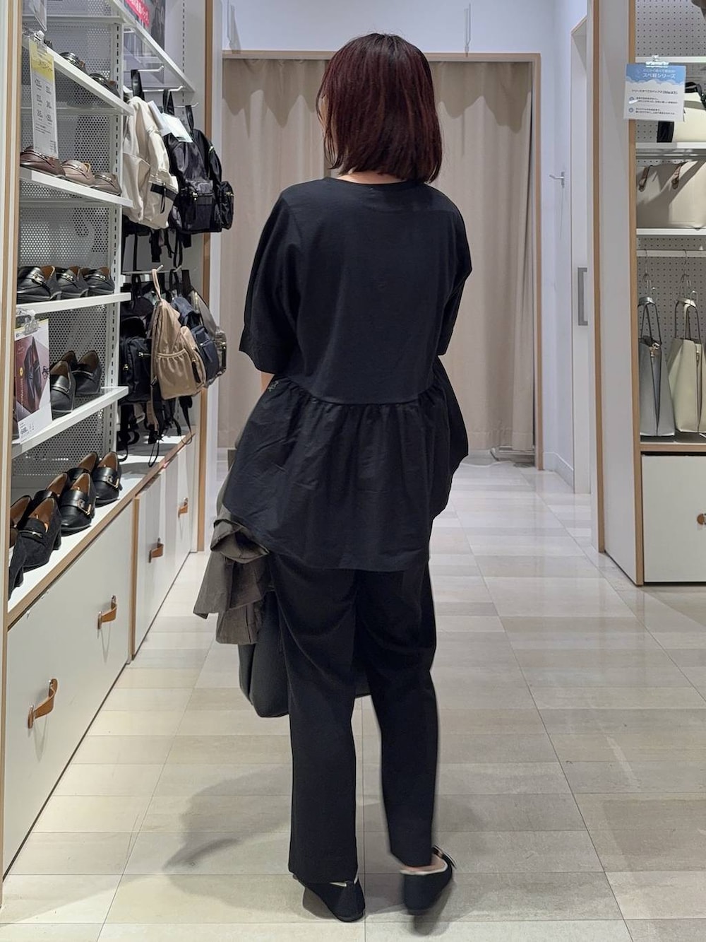 ブラック系のショルダーバッグ、ブラック系のスラックス、その他のパンプスを着用したレディースの秋コーディネートの7枚目の写真