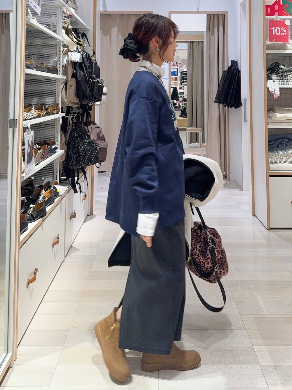 ホワイト系のブルゾン、グレー系のスカート、ホワイト系のTシャツ/カットソーを着用したレディースの冬コーディネートの6枚目の写真