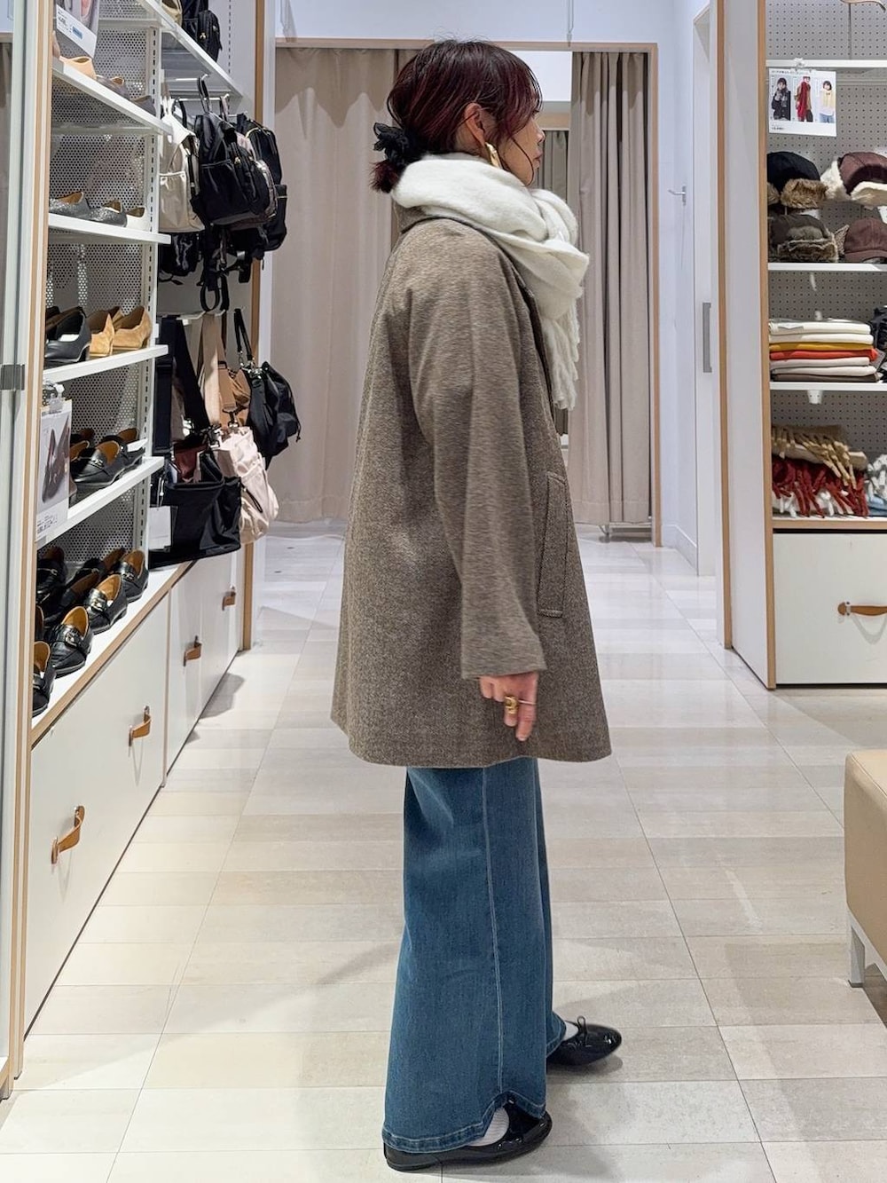 ブラック系のバレエシューズ、ブラウン系のチェスターコート、ブラウン系のニット/セーターを着用したレディースの冬コーディネートの4枚目の写真