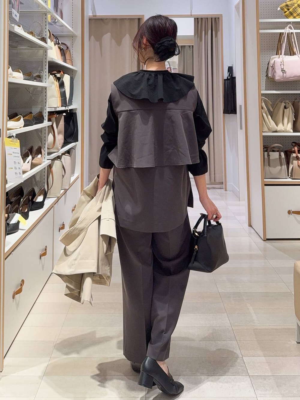 ブラック系のショルダーバッグ、ブラック系のローファー、グレー系のセットアップを着用したレディースの冬コーディネートの9枚目の写真