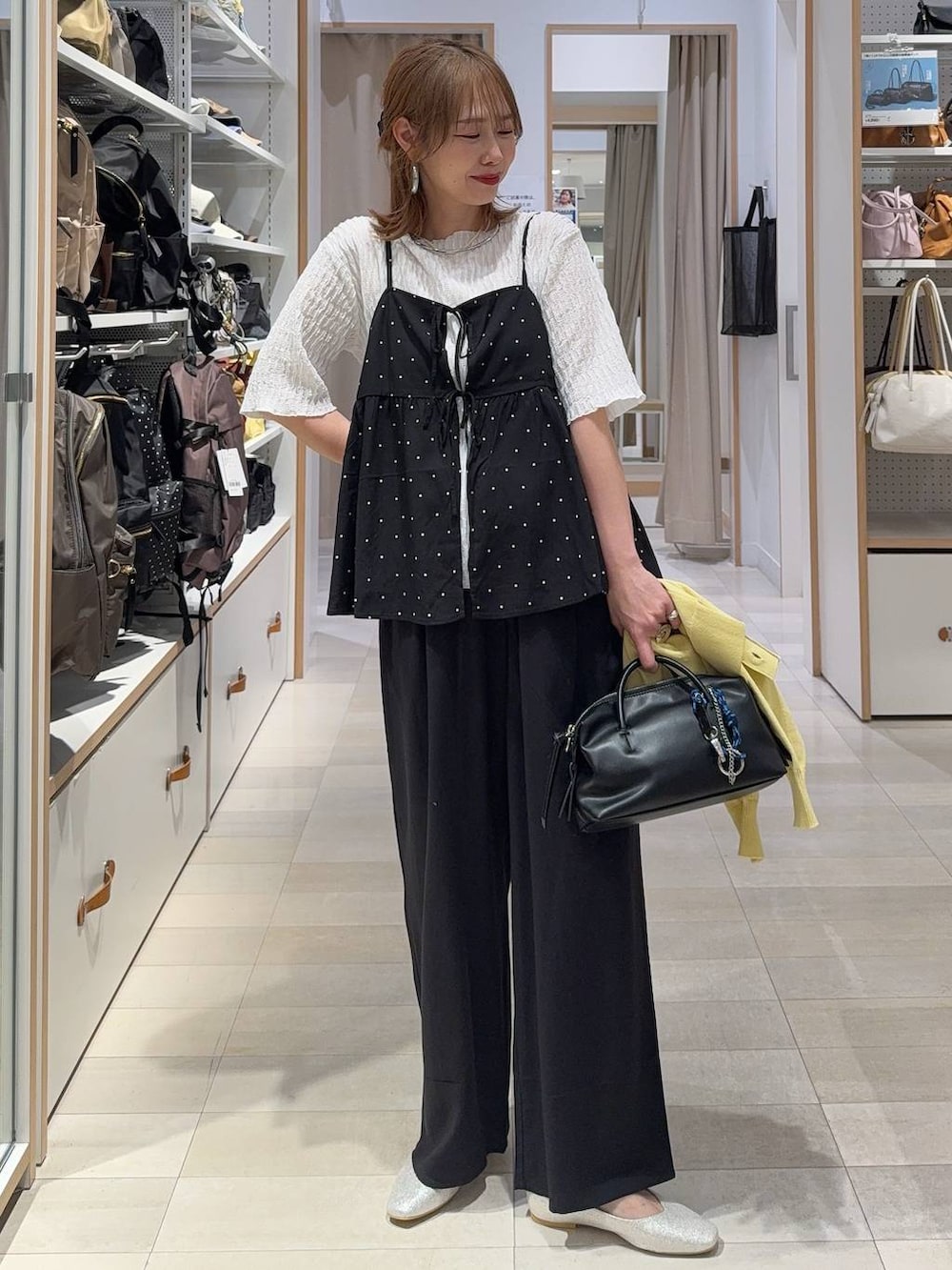ベージュ系のパンプス、イエロー系のカーディガン/ボレロ、ブラック系のその他パンツを着用したレディースの春コーディネートの3枚目の写真