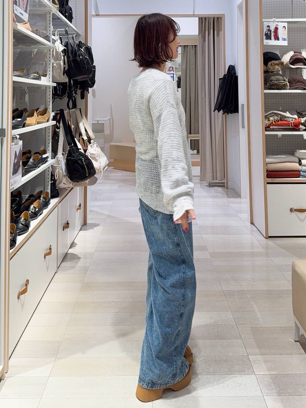 ブラック系のショルダーバッグ、グレー系のニット/セーター、イエロー系のブーツを着用したレディースの冬コーディネートの7枚目の写真