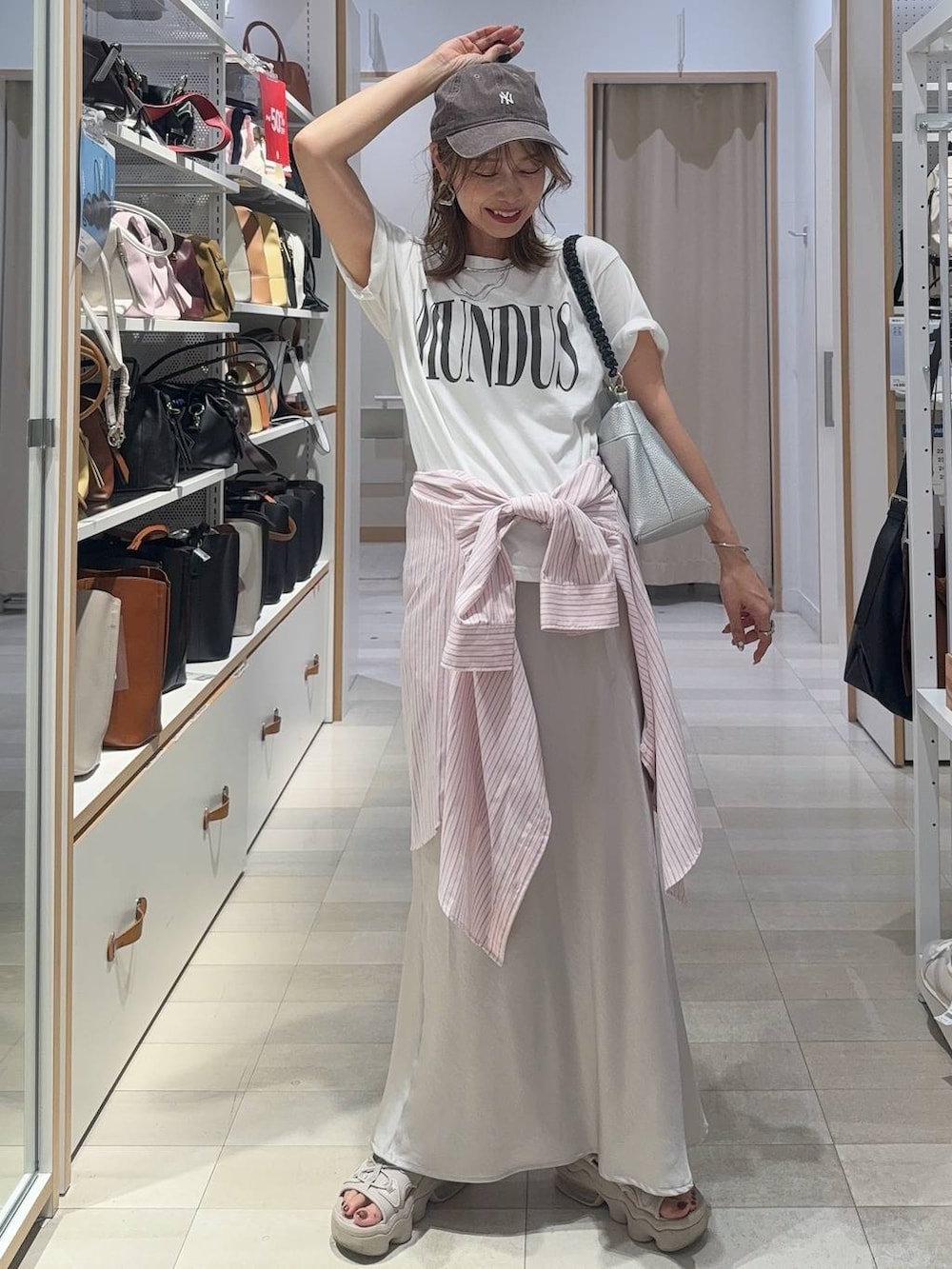 ピンク系のシャツ/ブラウス、グレー系のスカート、ホワイト系のTシャツ/カットソーを着用したレディースの夏コーディネートの3枚目の写真