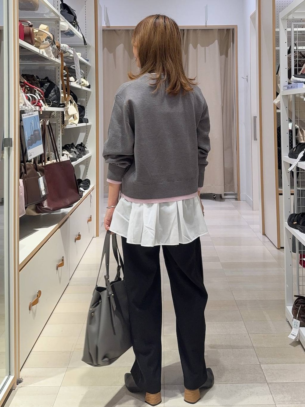 グレー系のトートバッグ、ホワイト系のTシャツ/カットソー、ブラック系のその他パンツを着用したレディースの秋コーディネートの9枚目の写真
