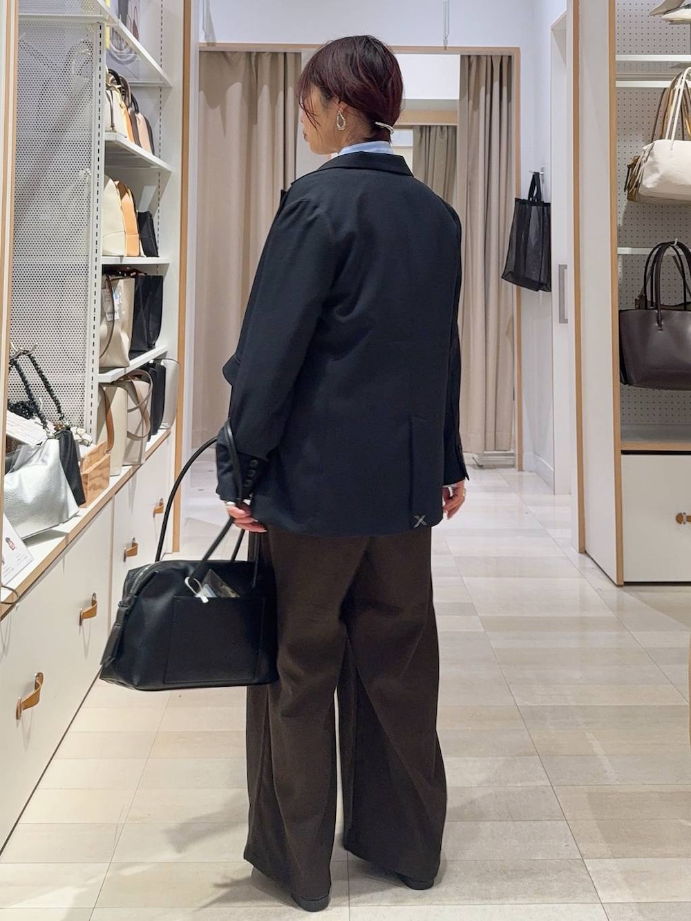 ブラック系のローファー、ブラック系のボストンバッグ、ブルー系のテーラードジャケットを着用したレディースの冬コーディネートの7枚目の写真