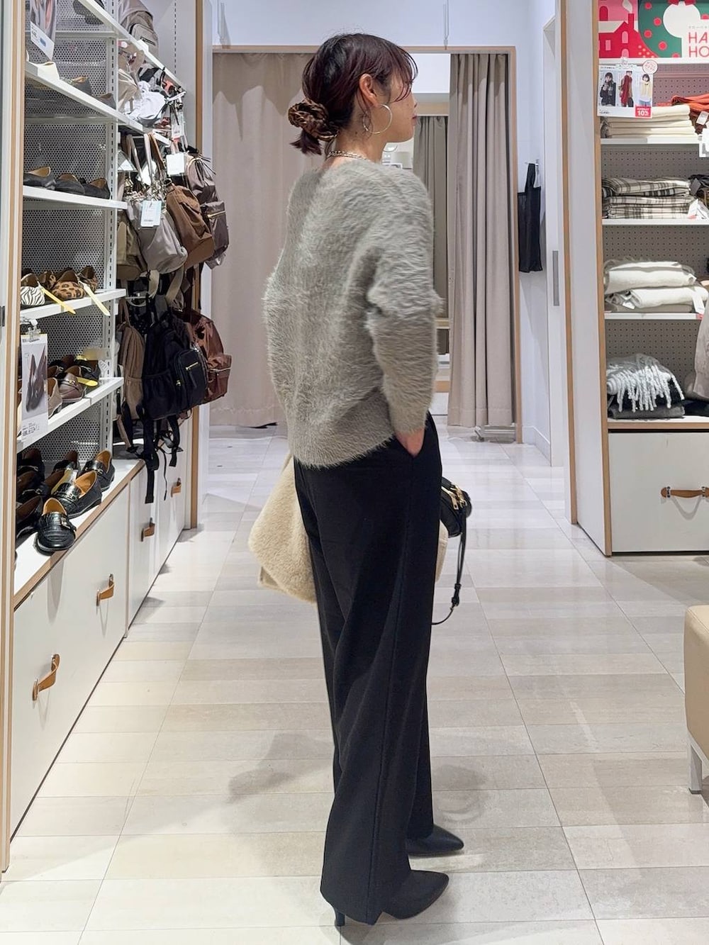 ブラック系のその他パンツ、ブラック系のハンドバッグ、ホワイト系のノーカラージャケットを着用したレディースの冬コーディネートの5枚目の写真