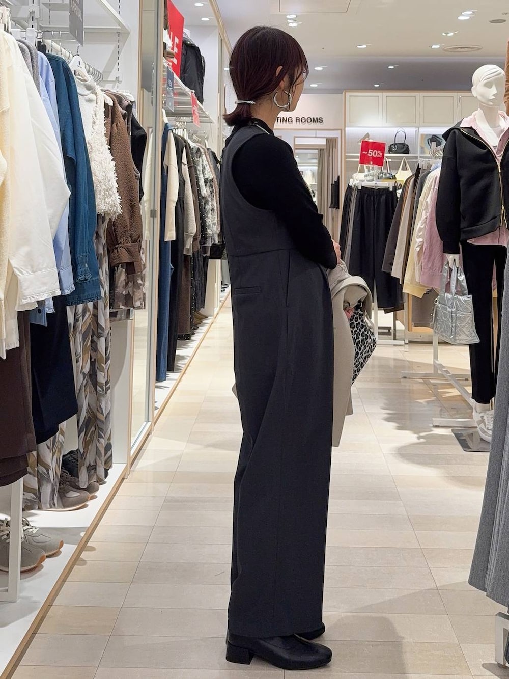 その他のショルダーバッグ、ブラック系のニット/セーター、ブラック系のブーツを着用したレディースの冬コーディネートの5枚目の写真