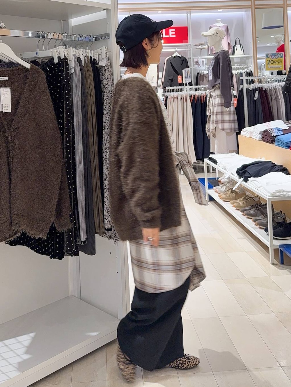 ベージュ系のニット/セーター、ブラック系のショルダーバッグ、ブラック系のブーツを着用したレディースの秋コーディネートの5枚目の写真