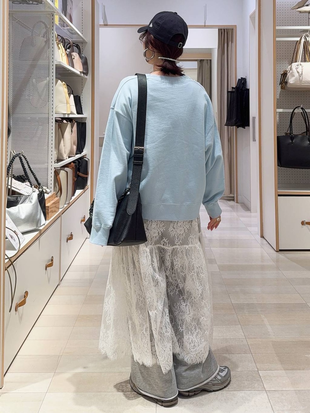 ブルー系のチェスターコート、グレー系のワンピース、ブルー系のスウェットを着用したレディースの冬コーディネートの9枚目の写真