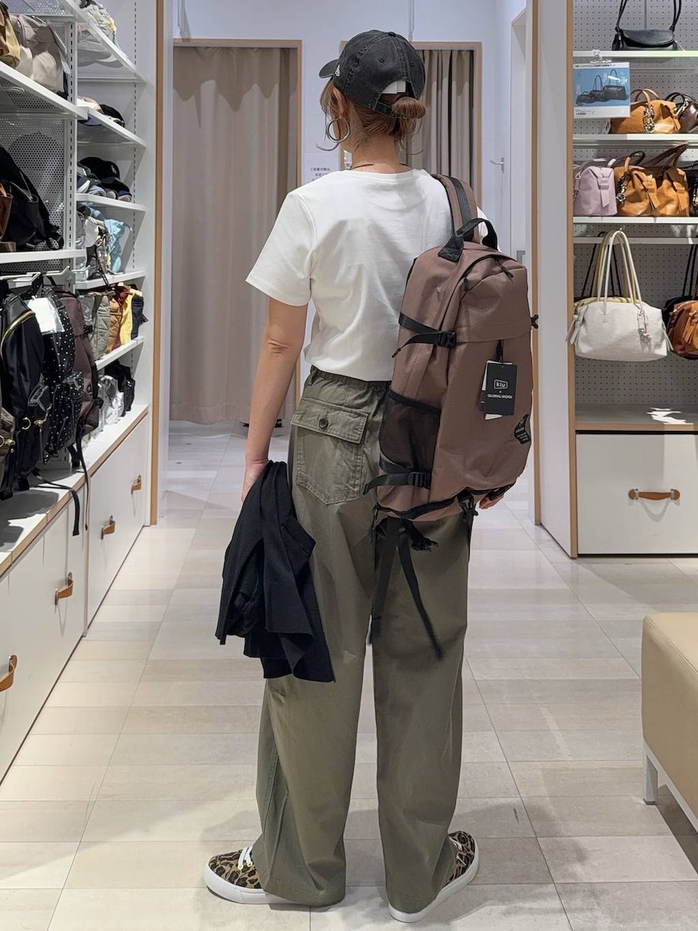 グリーン系のその他パンツ、その他のスニーカー、ブラック系のカーディガン/ボレロを着用したレディースの春コーディネートの8枚目の写真