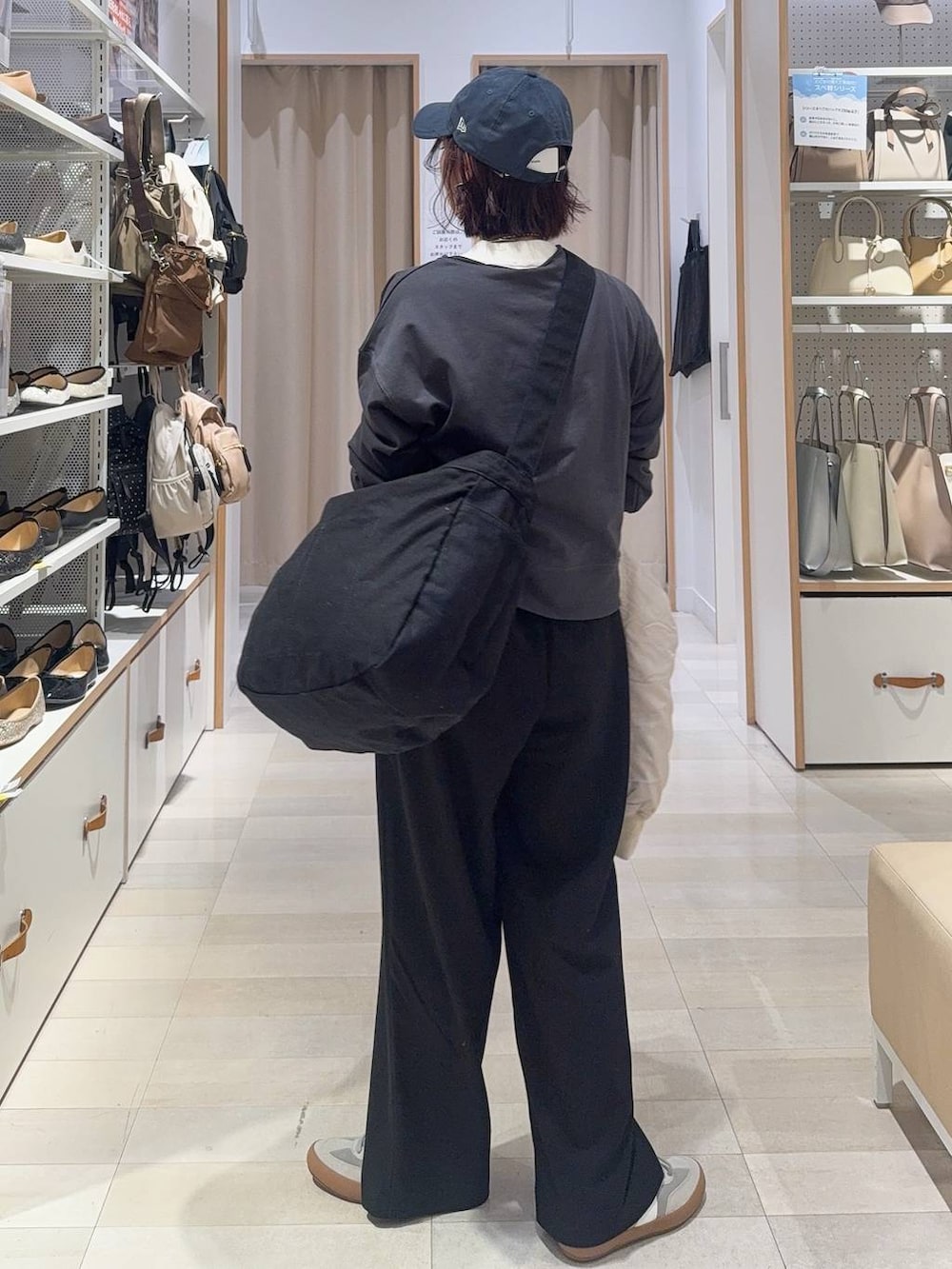 グレー系のスニーカー、ブラック系のショルダーバッグ、ベージュ系のブルゾンを着用したレディースの秋コーディネートの6枚目の写真