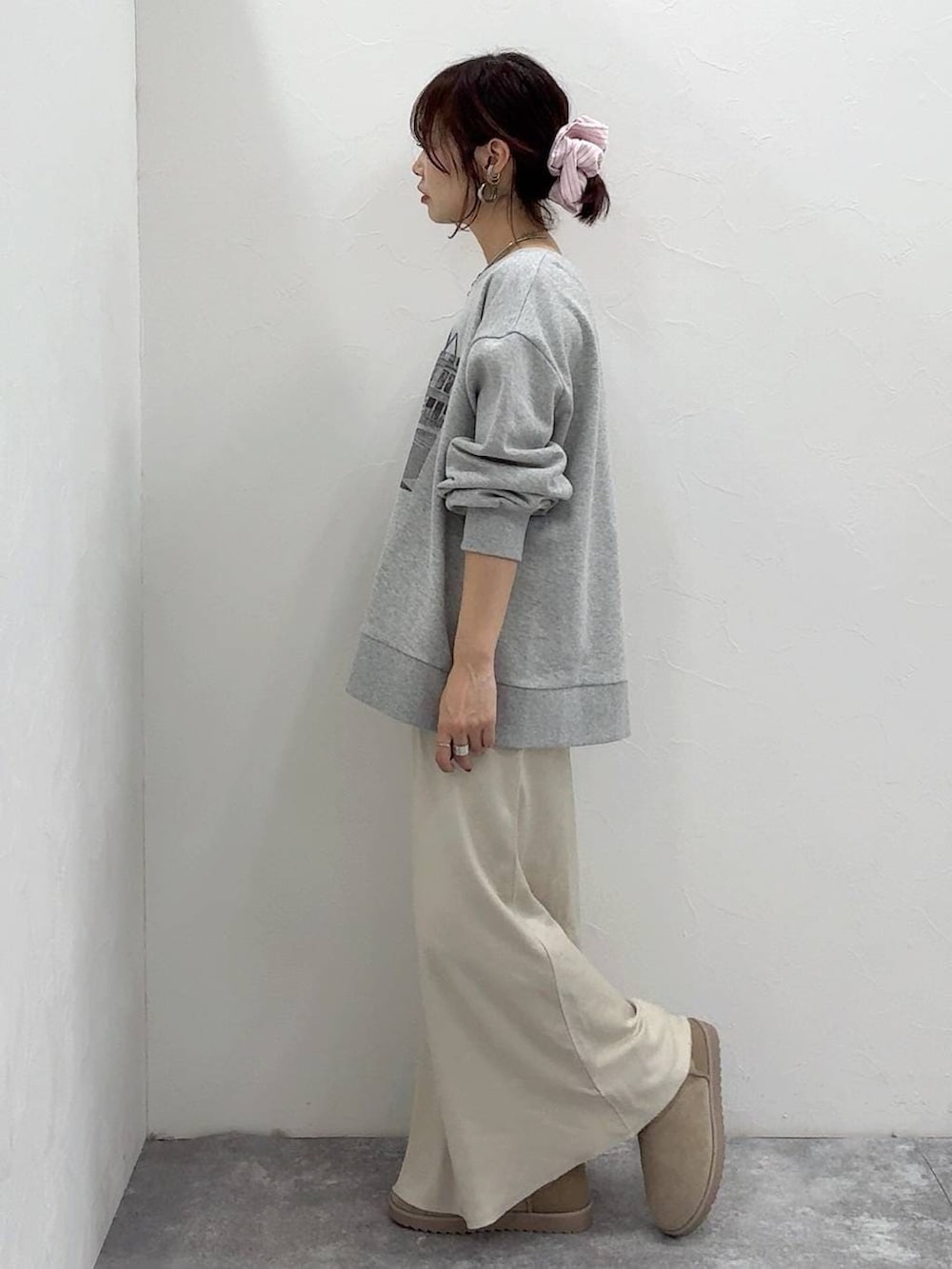 ホワイト系のショルダーバッグ、ブラック系のダウンジャケット/コート、ホワイト系のスカートを着用したレディースの冬コーディネートの8枚目の写真