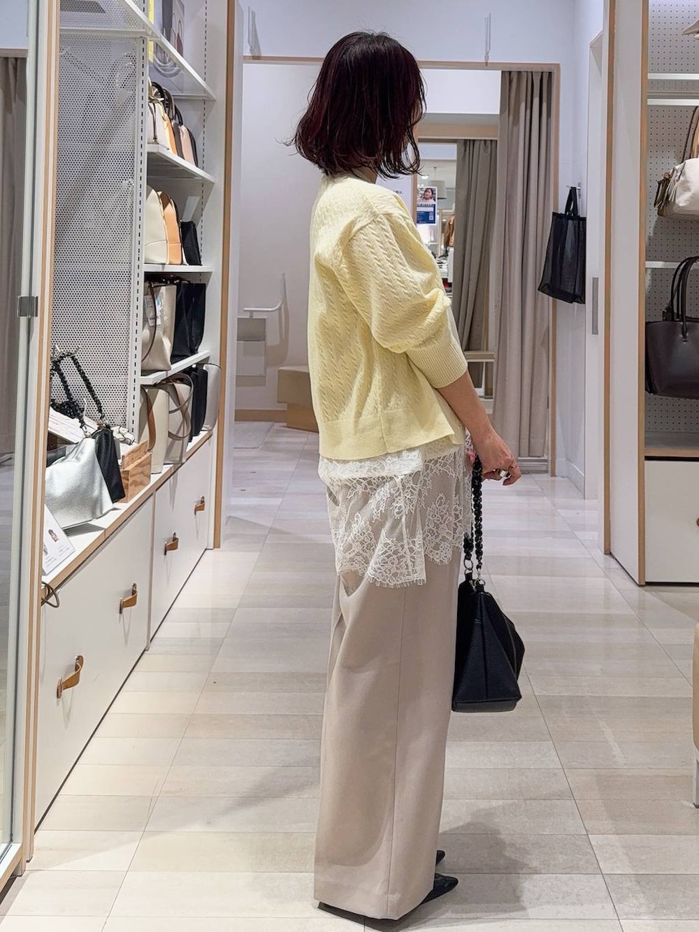 ゴールド系のタンクトップ、ブルー系のチェスターコート、イエロー系のカーディガン/ボレロを着用したレディースの冬コーディネートの6枚目の写真