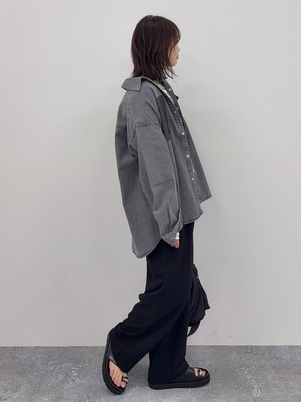 ブラック系のショルダーバッグ、ブラック系のその他パンツ、シルバー系のネックレスを着用したレディースの春コーディネートの3枚目の写真