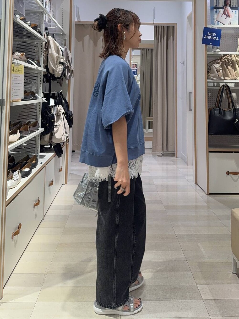 ブラック系のサンダル、ブラック系のTシャツ/カットソー、ブルー系のデニムパンツを着用したレディースの夏コーディネートの5枚目の写真