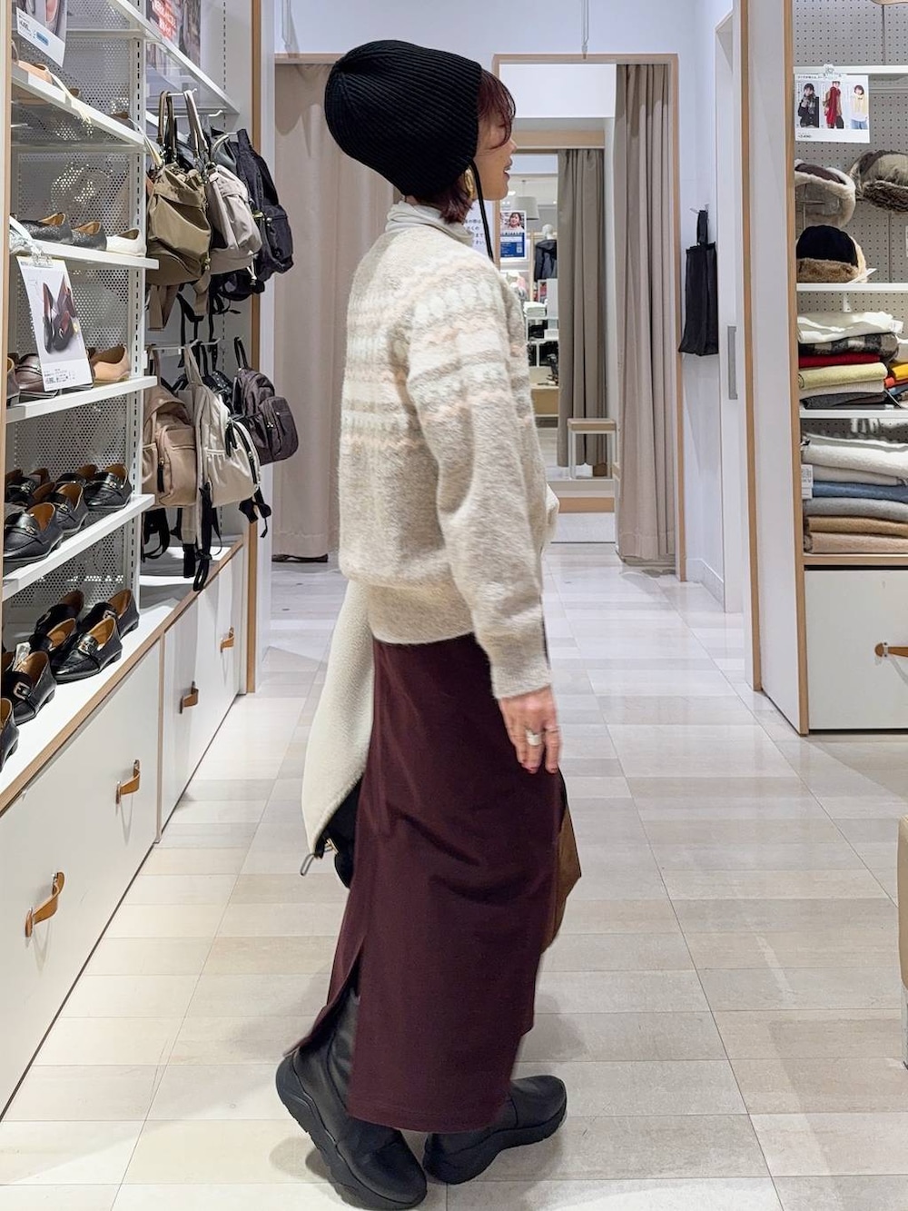 ホワイト系のブルゾン、レッド系のスカート、ベージュ系のトートバッグを着用したレディースの秋コーディネートの6枚目の写真