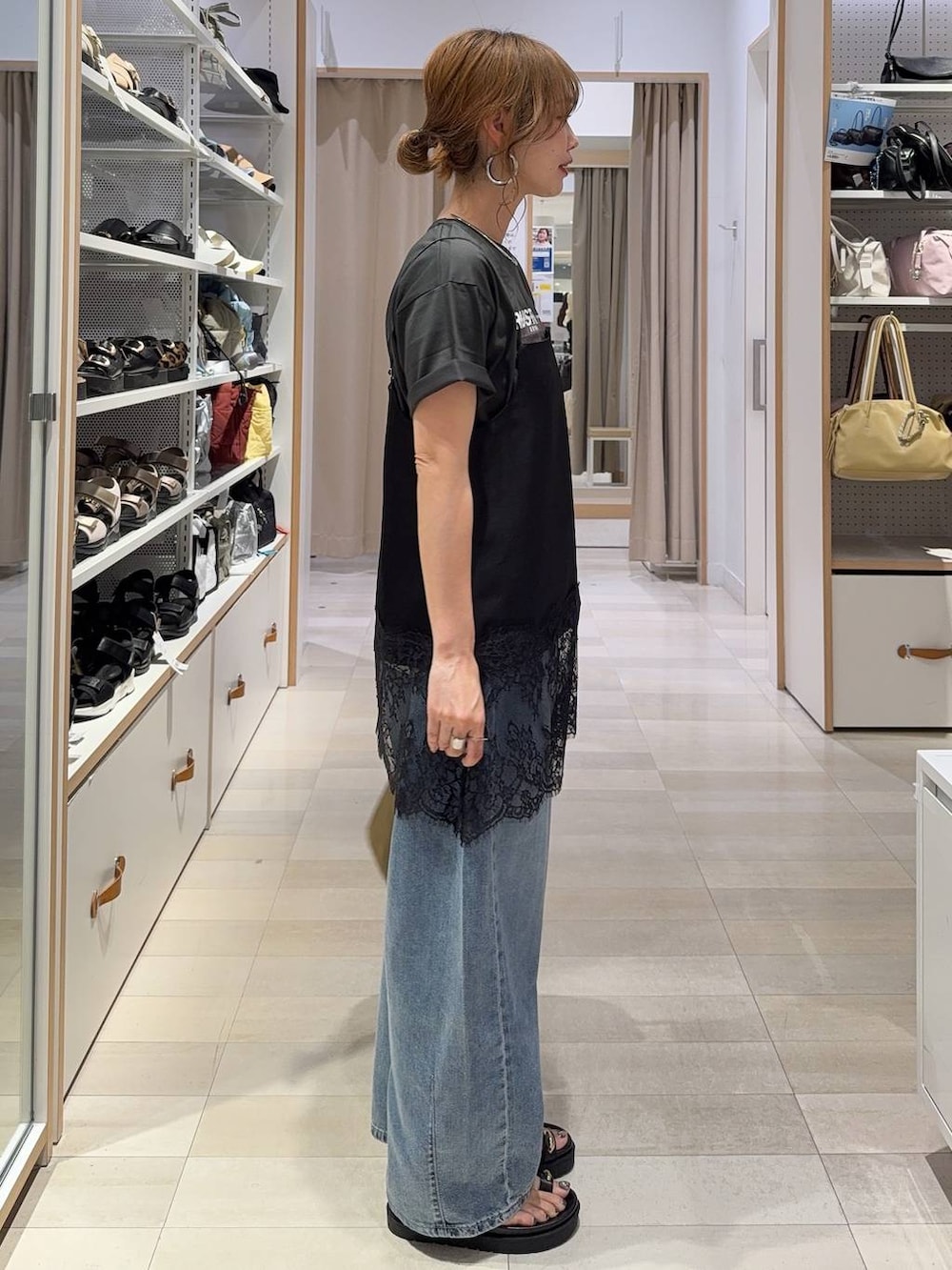 ブルー系のデニムパンツ、ブラウン系のテーラードジャケット、ブラック系のキャミソールを着用したレディースの夏コーディネートの8枚目の写真