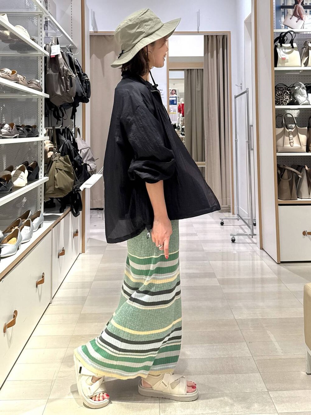 ブラック系のTシャツ/カットソー、ブラック系のブルゾン、グリーン系のスカートを着用したレディースの春コーディネートの5枚目の写真