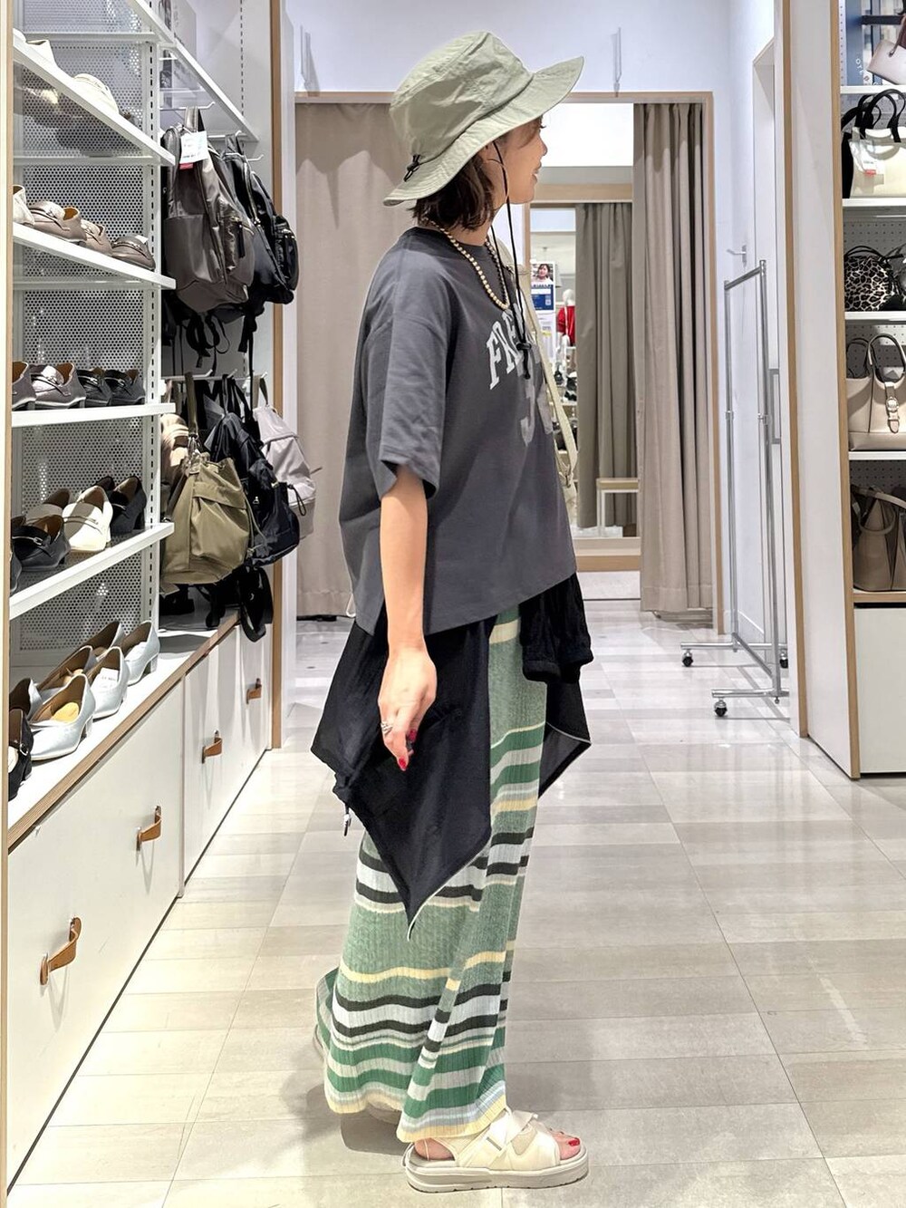 ブラック系のTシャツ/カットソー、ブラック系のブルゾン、グリーン系のスカートを着用したレディースの春コーディネートの3枚目の写真