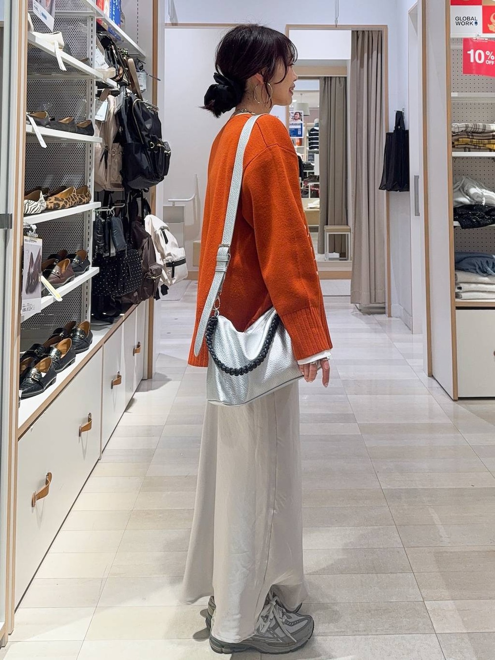 ホワイト系のTシャツ/カットソー、グレー系のスカート、シルバー系のネックレスを着用したレディースの冬コーディネートの7枚目の写真