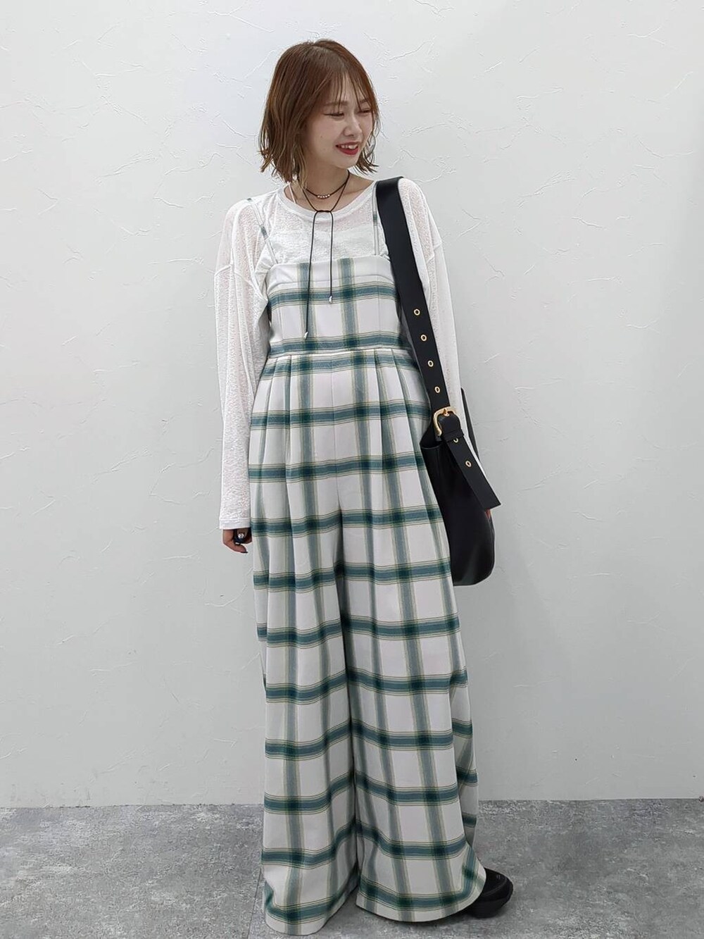 ホワイト系のTシャツ/カットソー、ブラック系のショルダーバッグ、ホワイト系のサロペット/オーバーオールを着用したレディースの春コーディネートの2枚目の写真