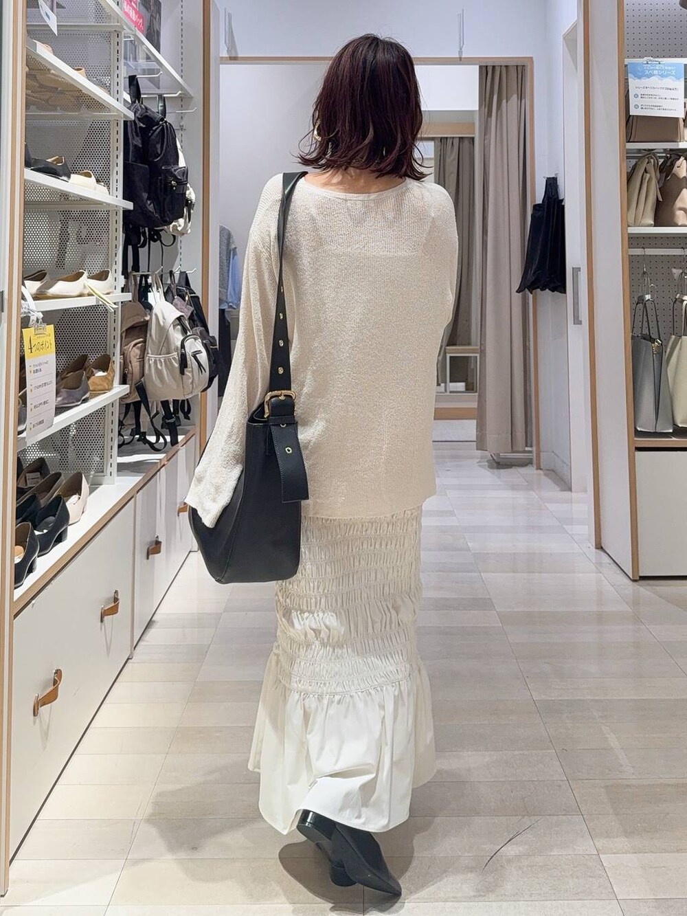 ホワイト系のスニーカー、ブラック系のキャミソール、ブラック系のハンドバッグを着用したレディースの秋コーディネートの7枚目の写真