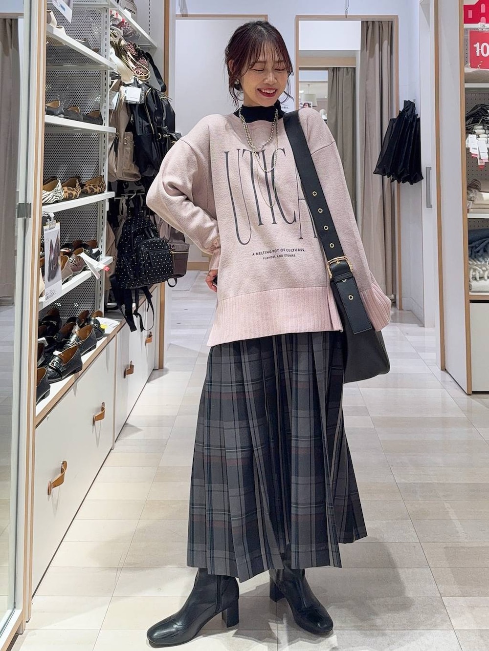 ブラック系のショルダーバッグ、ブルー系のチェスターコート、グレー系のスカートを着用したレディースの冬コーディネートの4枚目の写真