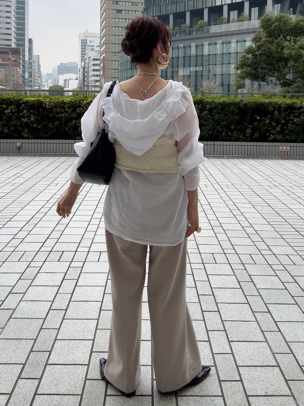 ホワイト系のキャミソール、ホワイト系のシャツ/ブラウス、ベージュ系のその他パンツを着用したレディースの冬コーディネートの9枚目の写真