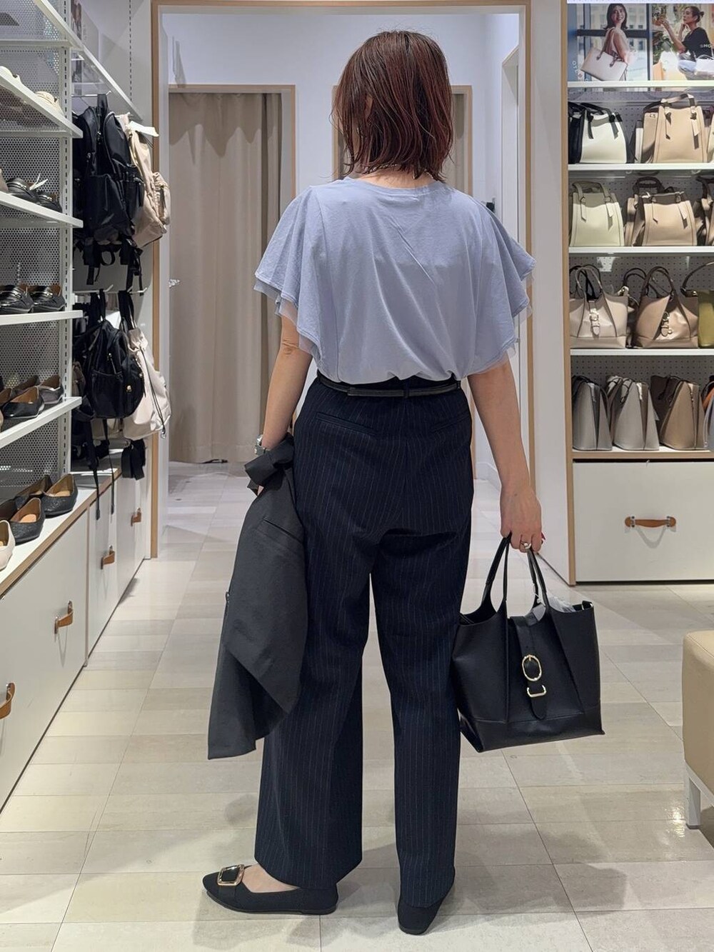 ブラック系のショルダーバッグ、ブラック系のパンプス、ブルー系のその他パンツを着用したレディースの夏コーディネートの7枚目の写真