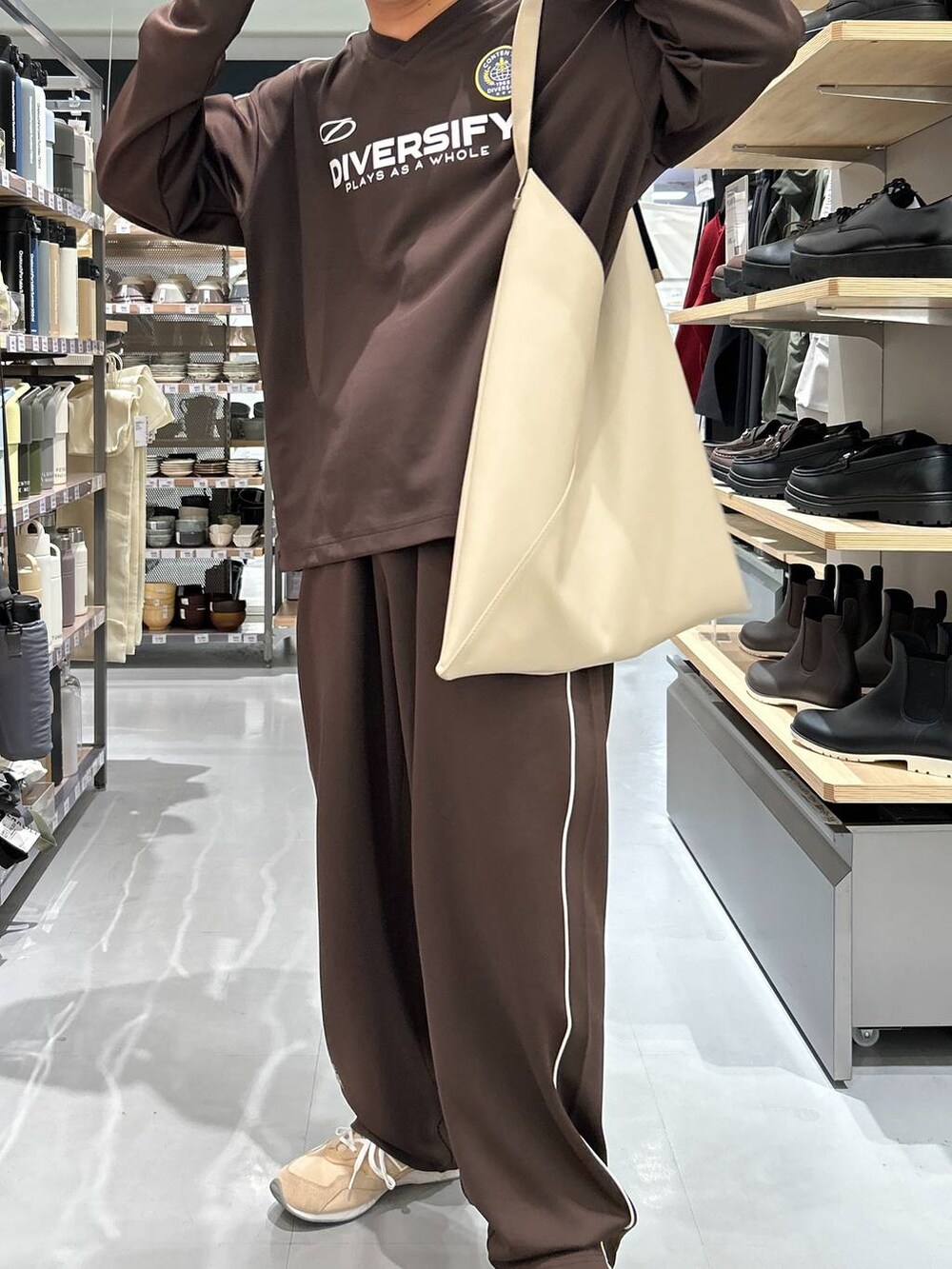 グレー系のトートバッグ、ブラウン系のその他パンツ、ブラウン系のTシャツ/カットソーを着用したメンズの秋コーディネートの4枚目の写真